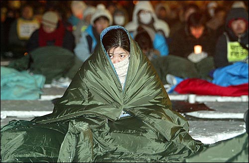 지난해 12월 30일 밤 11시경 국회앞에서 국가보안법 연내폐지를 촉구하며 농성을 벌이는 참가자들에게 '국가보안법 처리를 내년으로 미룬다'는 내용이 포함된 열린우리당과 한나라당의 합의문이 전달됐다. 국회앞에서 농성중인 집회 참가자들이 망연자실한 표정으로 합의문 내용을 듣고 있다. 